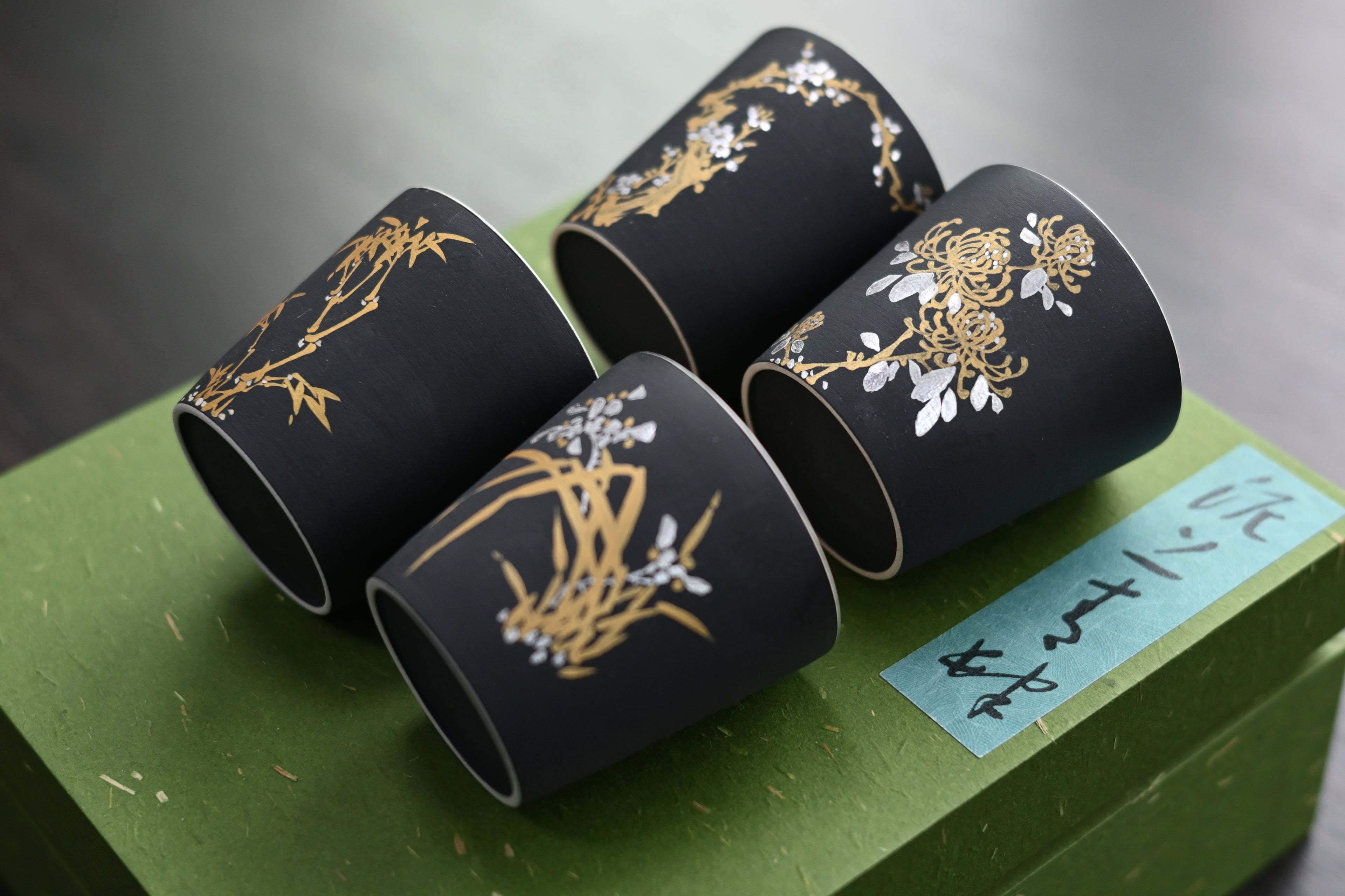 Four Gentlemen Matte Black Tea Cup – Handcrafted Ceramic with Nature Patterns