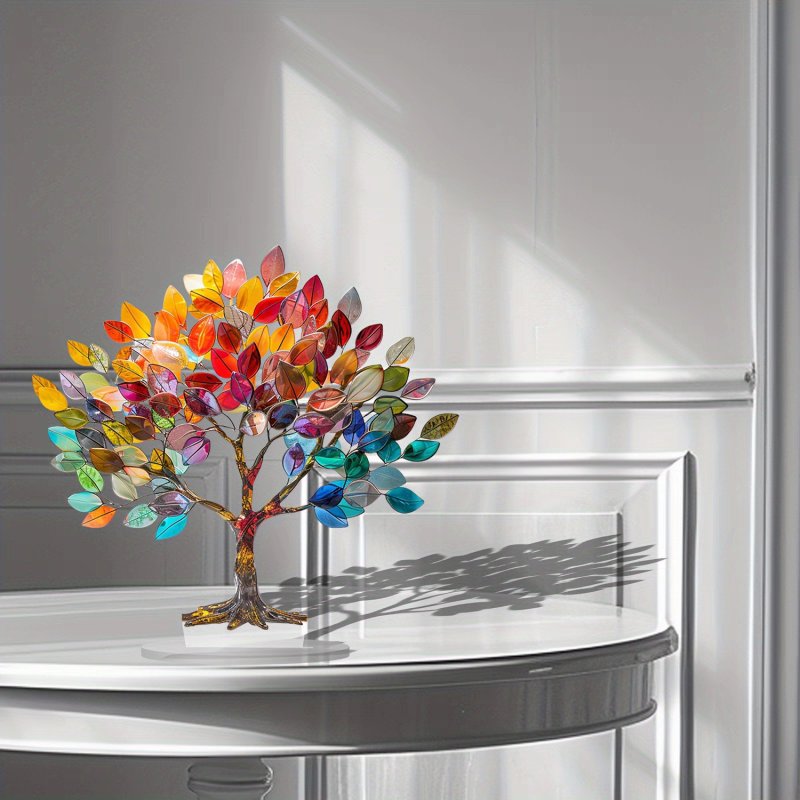 Colorful tree-shaped decorative item on a white surface with a neutral background