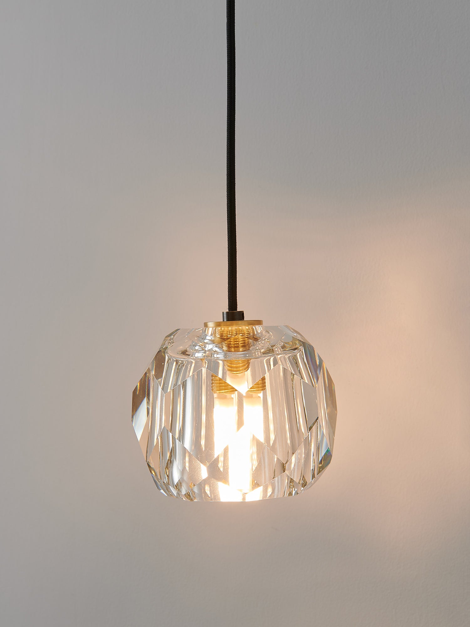 Multi-faceted clear crystal wall sconce