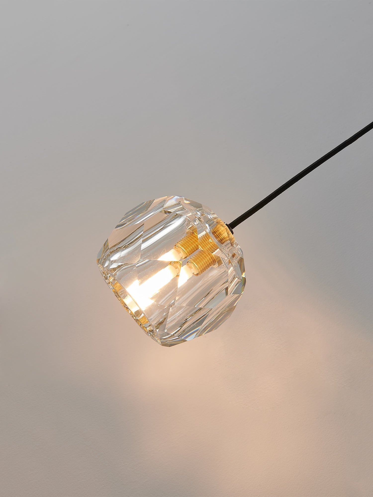 Multi-faceted clear crystal wall sconce