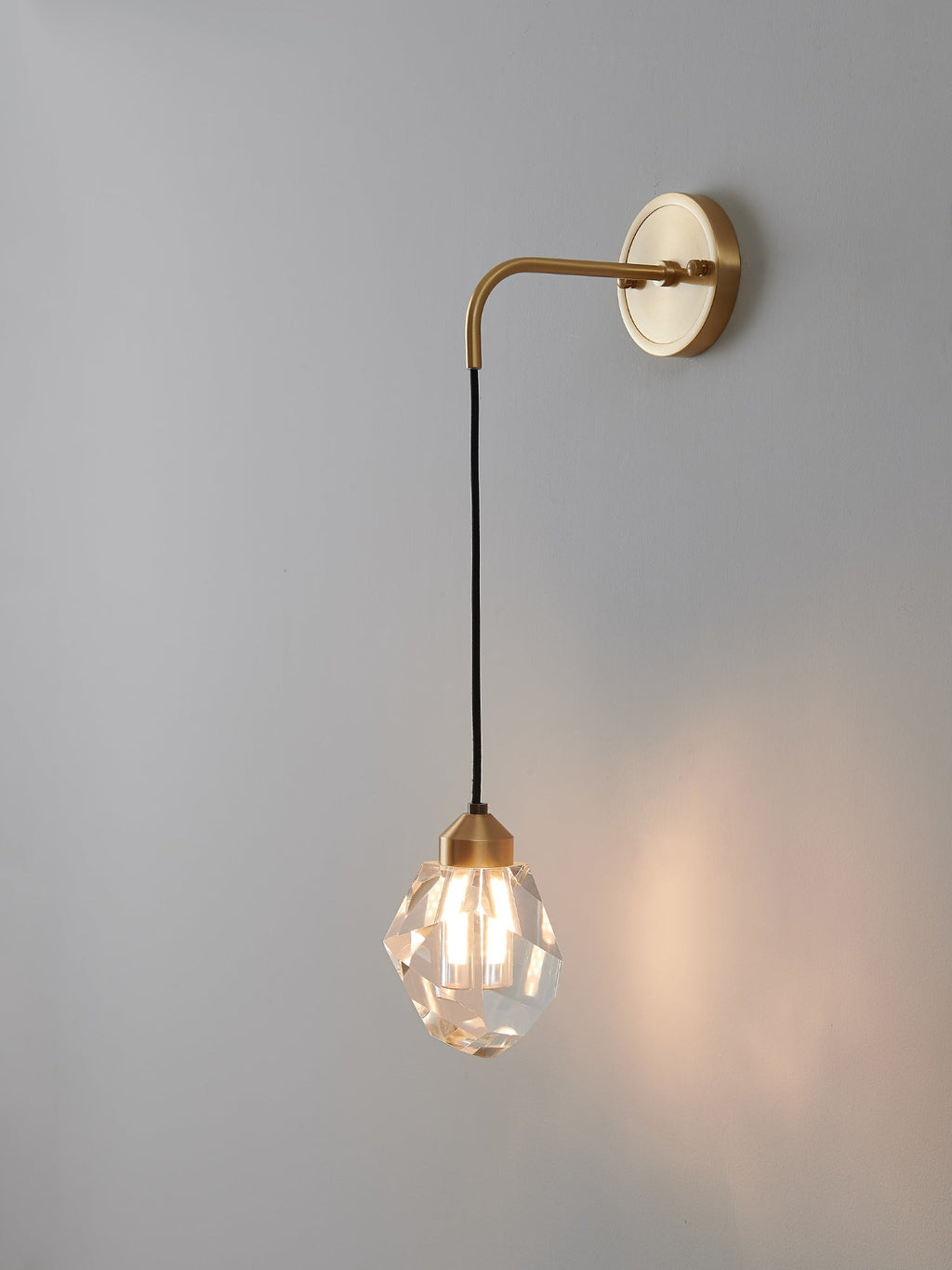 Multi-faceted clear crystal wall sconce