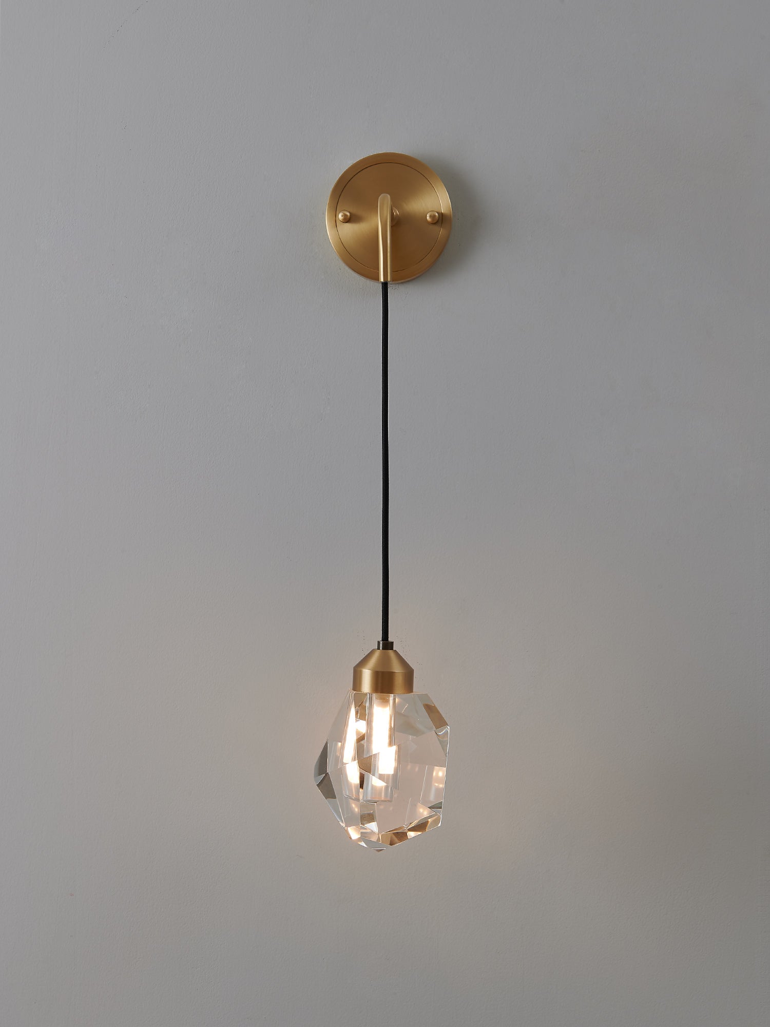 Multi-faceted clear crystal wall sconce