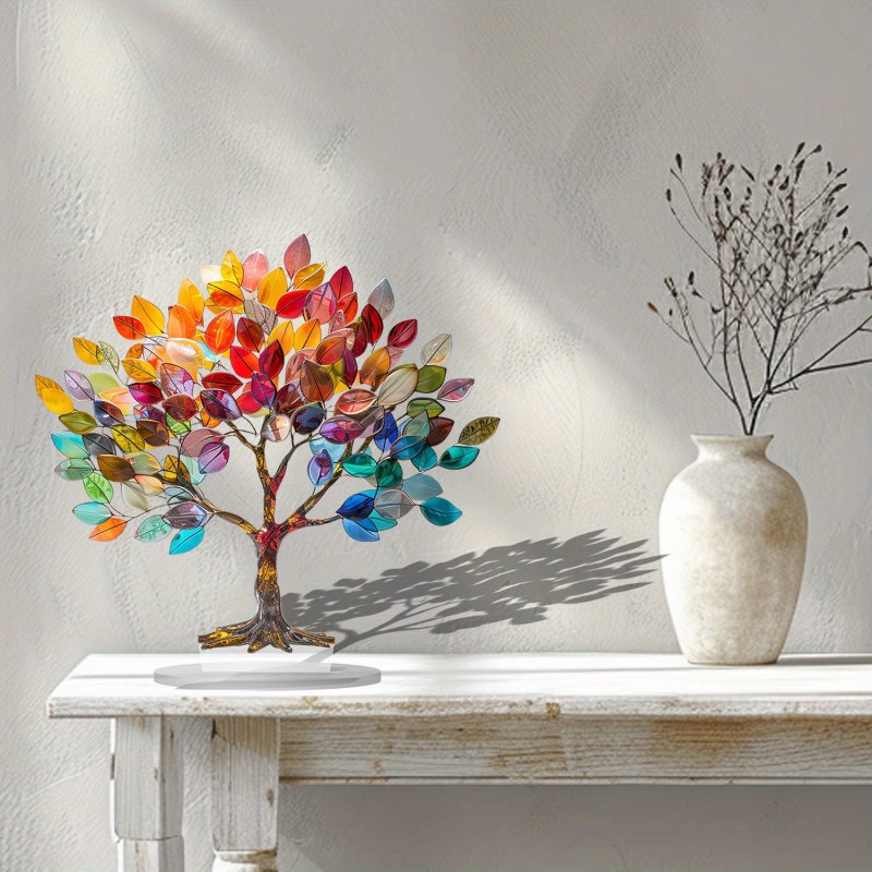 Colorful tree sculpture on a white surface with a neutral background